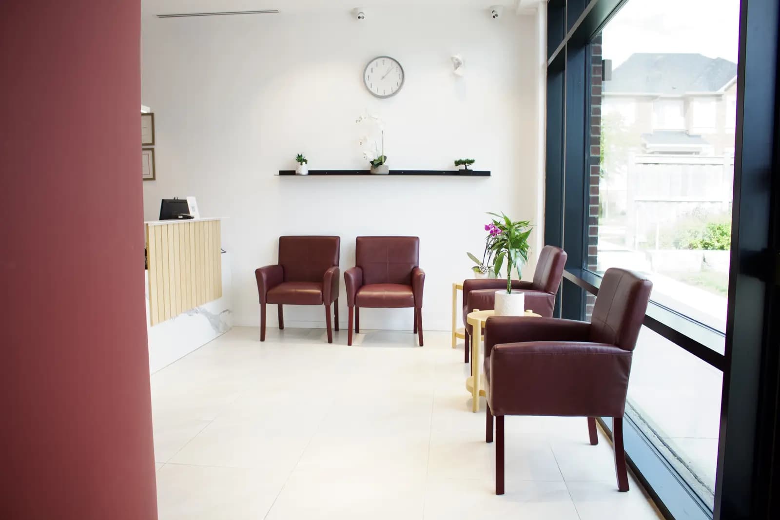 Bright waiting lounge with leather armchairs and street-facing windows