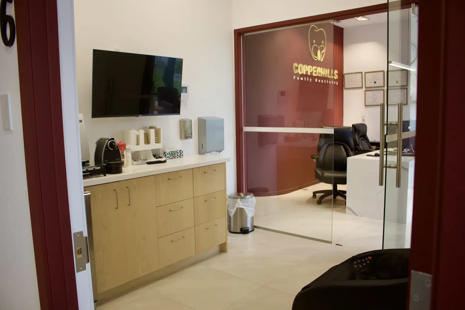 Private consultation suite with a wall-mounted display screen