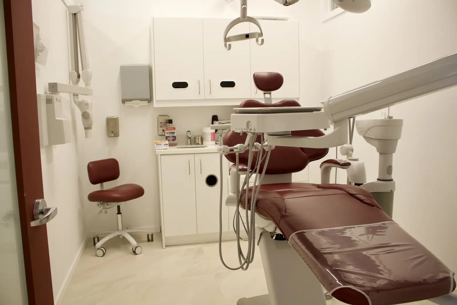 Treatment room with a modern dental chair and overhead light